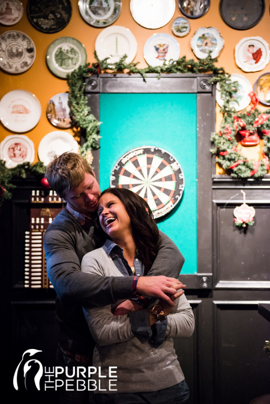 couple playing darts engagement photography