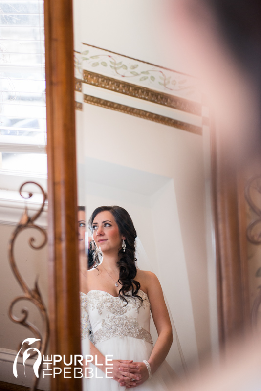 bride looking in the mirror wedding gown